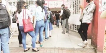Students wait to submit their examination papers