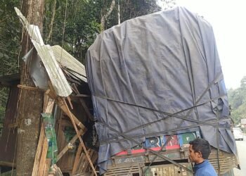 Driver rams truck into highway shop